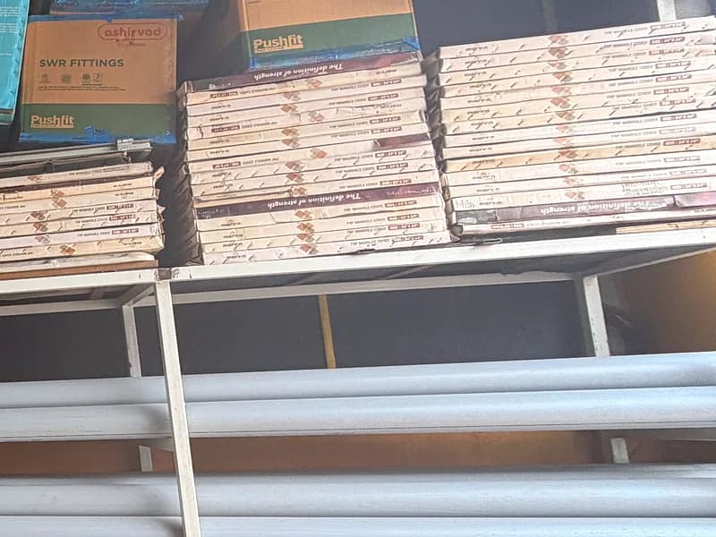Boxed floor and wall tiles stacked on the showroom storage racks