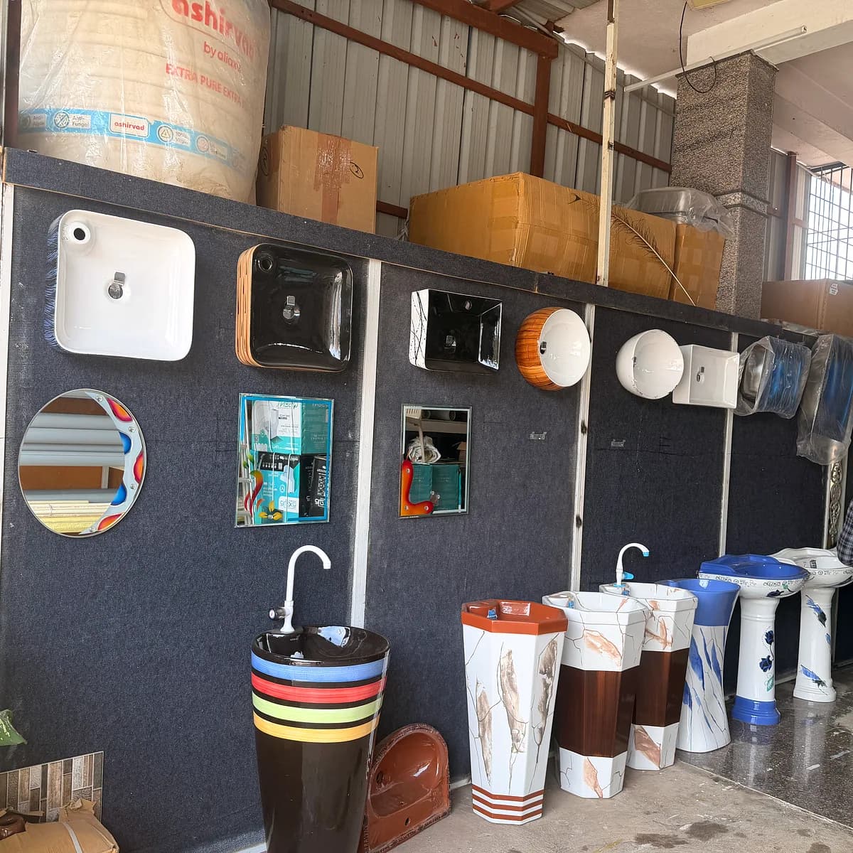 The shop entrance beneath the Mathaji Ceramics signboard, with tiles and sanitaryware on display