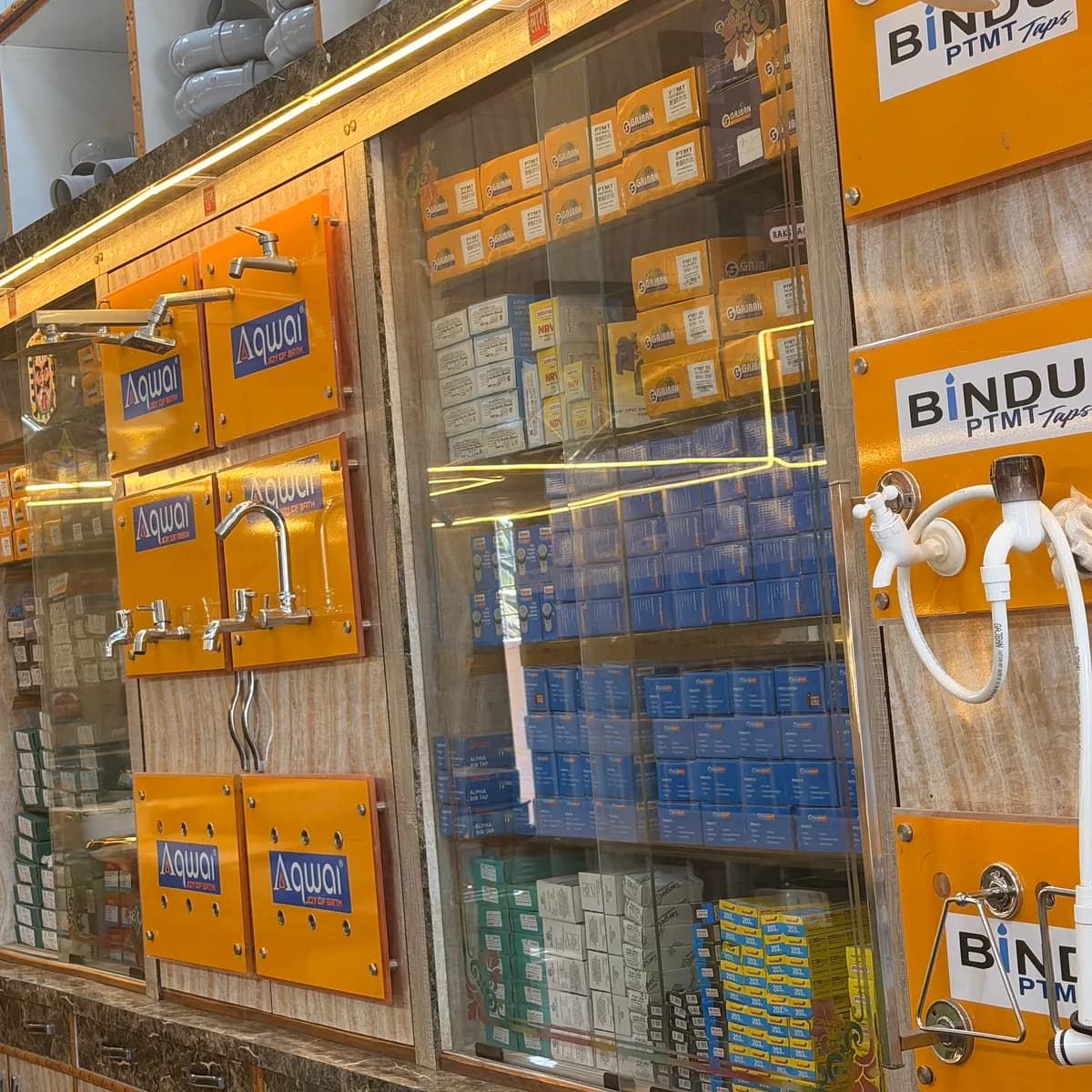 The fittings counter, with taps on display above glass cases of boxed stock